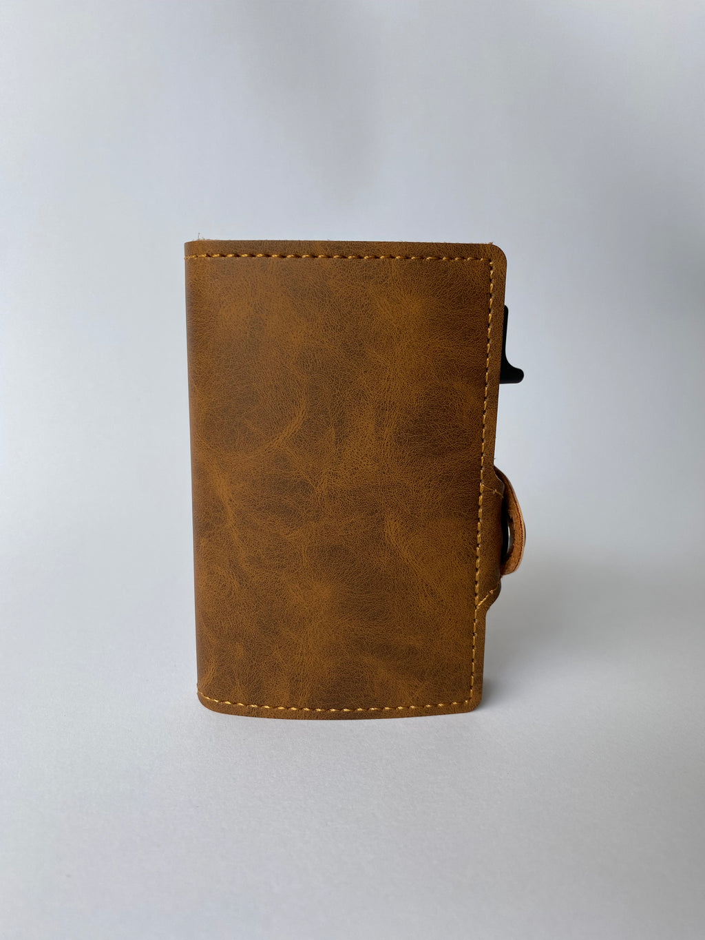 Minimalist RFID wallet with pop up mechanism and space for cash and cards