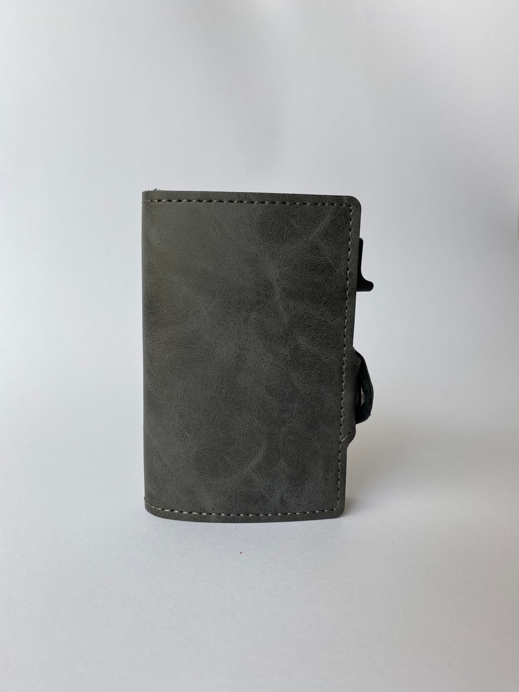 Minimalist RFID wallet with pop up mechanism and space for cash and cards