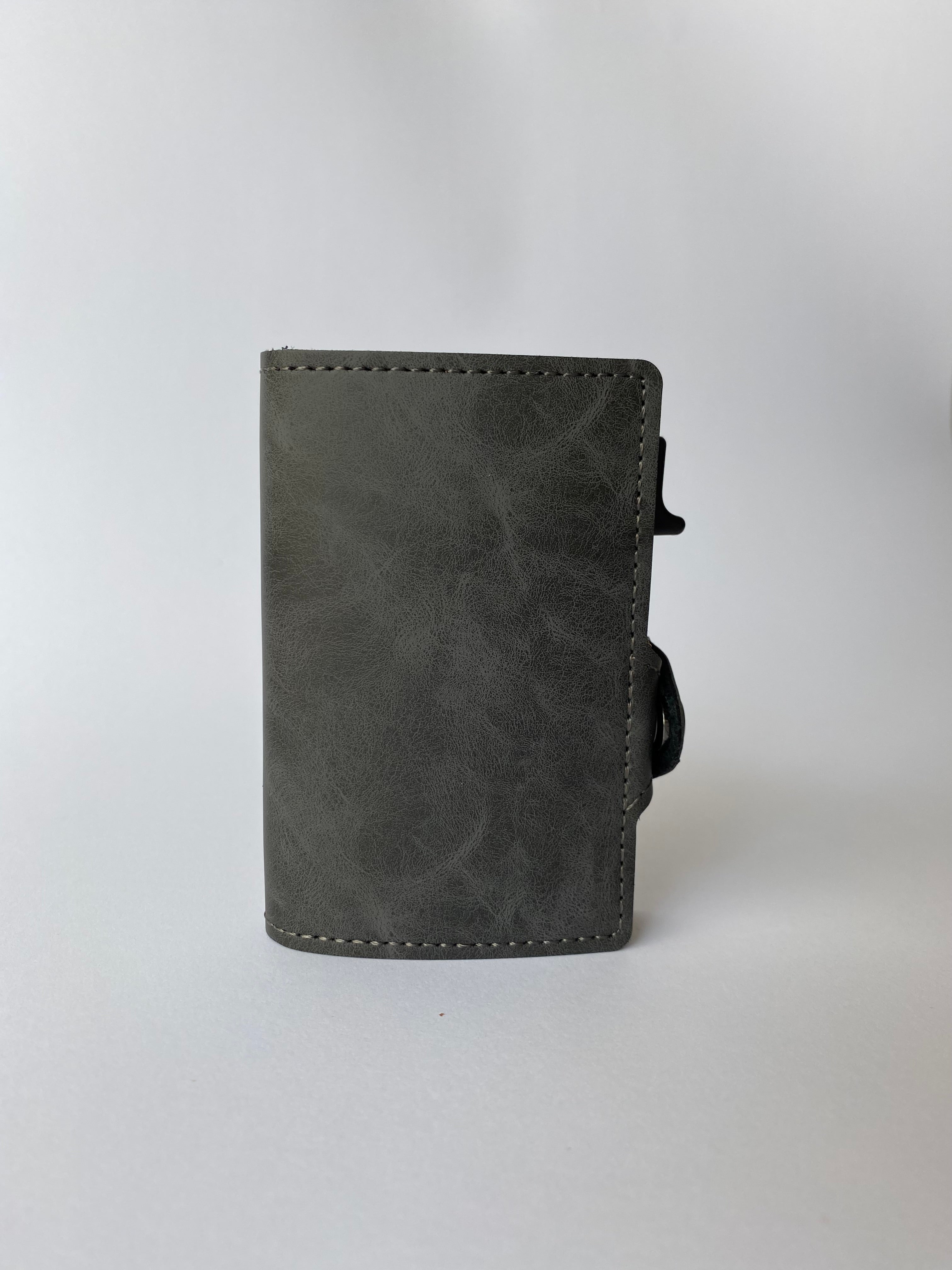 Minimalist RFID wallet with pop up mechanism and space for cash and cards